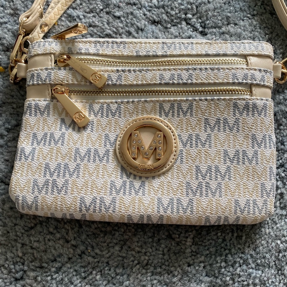 Milan adjustable cross body or wrist clutch bag.